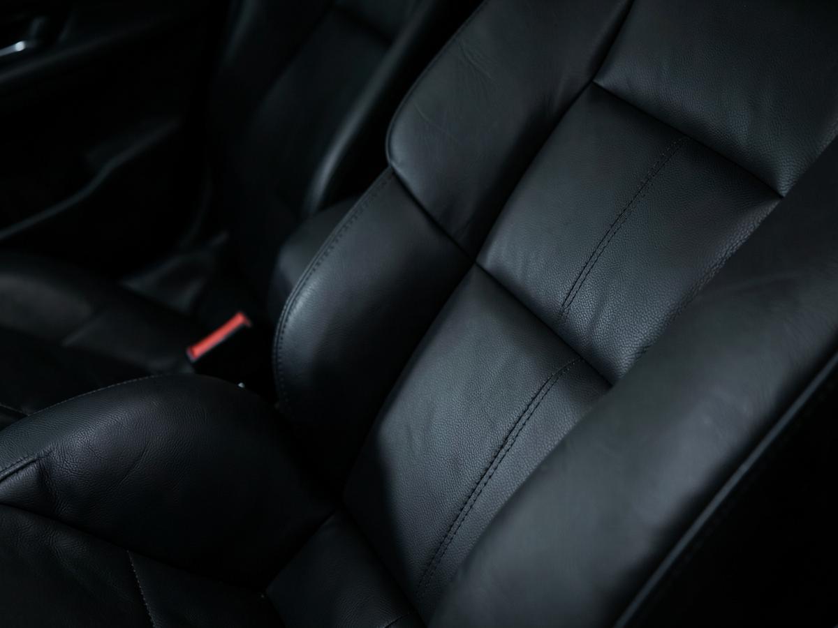 Conditioned black leather seats with clean stitching
